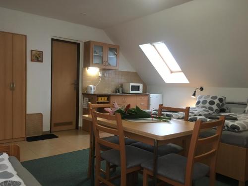 a kitchen and dining room with a table and chairs at Penzion Amálka in Třeboň