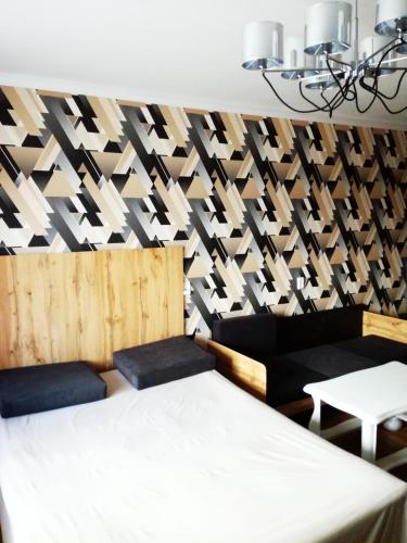 ヨシュカル・オラにあるКвартира Первомайская 86のベッド1台と椅子2脚、壁が備わる客室です。