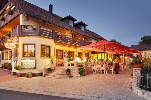 a restaurant with tables and chairs in front of a building at Hotel Schloßberg in Gräfenberg