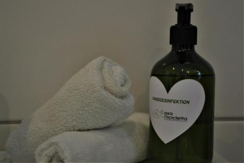 a bottle of soap next to a stuffed animal next to a towel at Casa Bicicletta in Fuschl am See