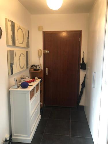 a kitchen with a door and a counter with a stove at Carpe Diem in Le Val-André