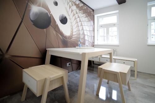 a table and two chairs in a room with a wall at Design-Ferienwohnungen Stadtidyll in Wernigerode