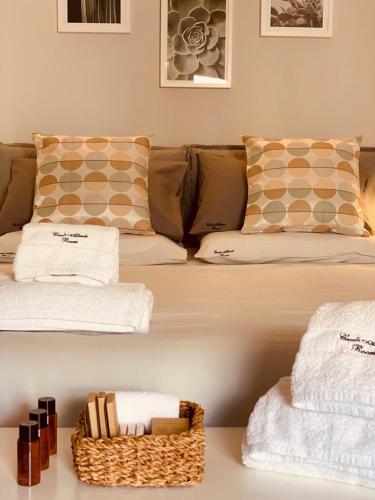 a living room with a couch and a basket of towels at Carlo Alberto Room in Fasano