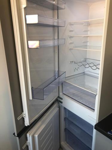 an empty refrigerator with its door open in a kitchen at Good Night apartaments in Panevėžys