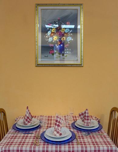a table with plates and napkins on top at Hotel Dolly in Viareggio