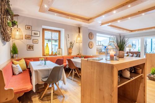a dining room and living room with a table and chairs at Hotel Seehof in Zell am See