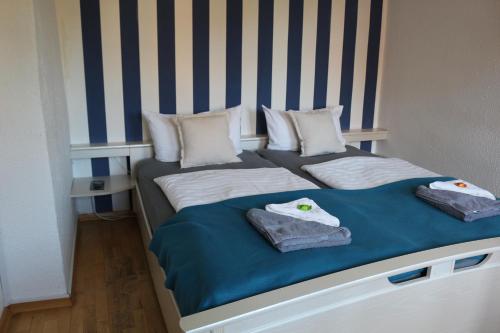 a bed with two pillows on top of it at Altstadtcafé und Pension in Havelberg