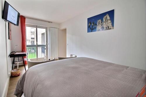 a white room with a bed and a window at Assia & Nathalie - Luxury B&B MARAIS in Paris