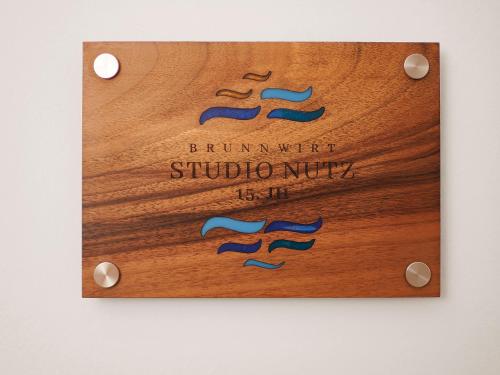 a wooden cutting board with a sign that reads brunswick institution studio music is life at Brunnwirt ESSEN & WOHNEN in Fuschl am See
