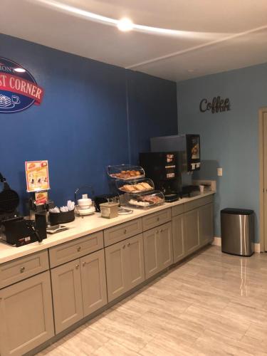 a restaurant with a counter with food on it at Baymont by Wyndham Kingwood in Kingwood