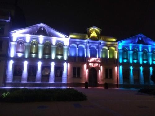 a building lit up in blue and green at Number15 Guesthouse Carcassonne in Carcassonne