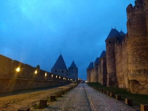 a street in front of a castle at night at Number15 Guesthouse Carcassonne in Carcassonne