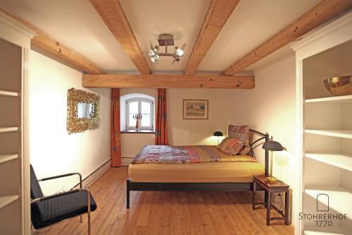 a bedroom with a bed with a wooden ceiling at 5 Sterne Ferienhaus Gut Stohrerhof am Ammersee bis 15 Personen in Dießen am Ammersee