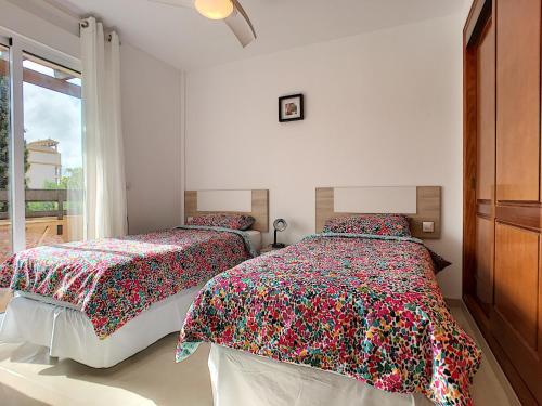 a bedroom with two beds and a window at Arona 2 - 0909 in Mar de Cristal