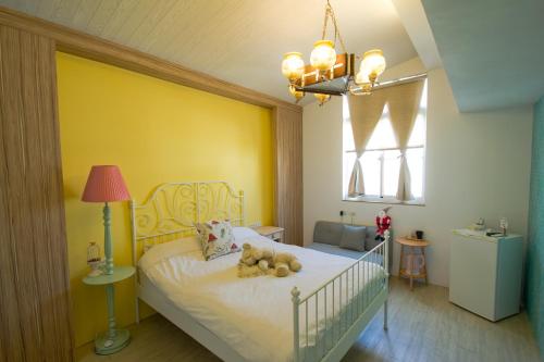 a bedroom with a bed with two teddy bears on it at Leaf Hostel in Tainan