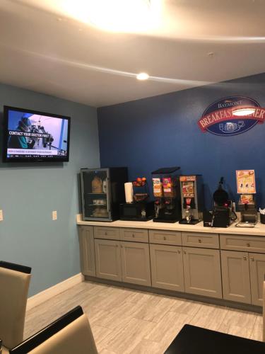 a waiting room with a tv on a blue wall at Baymont by Wyndham Kingwood in Kingwood