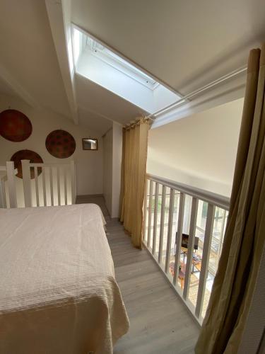a bedroom with a bed and a large window at Maison de vacance proche de la mer in Les Sables-dʼOlonne