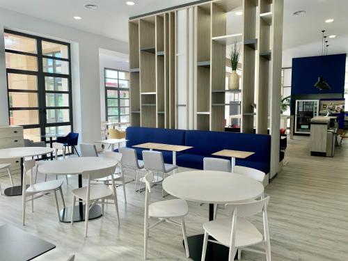 
a restaurant with tables and chairs in it at Holiday Inn Express Ciudad de las Ciencias, an IHG Hotel in Valencia
