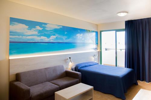 a room with a couch and a bed and a window at Festival Village Apartments in Salou
