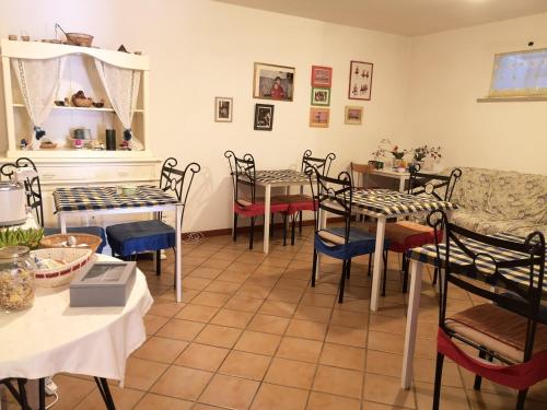 a restaurant with tables and chairs in a room at A Due Passi Dal Mare B&B in Numana