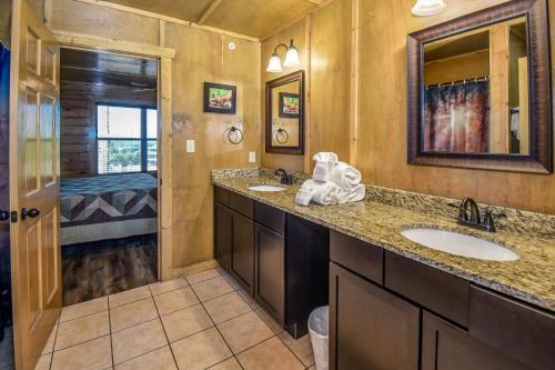 a bathroom with two sinks and a shower at SmokyStays 10 Bedroom Cabin in Pigeon Forge