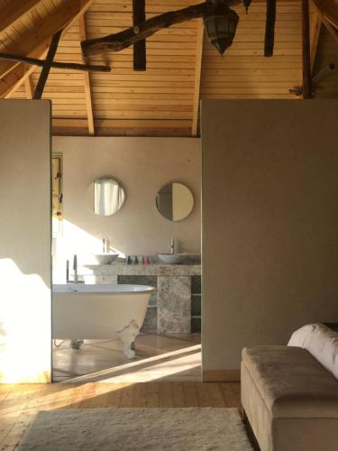 a large bathroom with a tub and a sink at Dar Hnini in Zagora