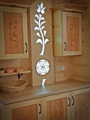 a kitchen with wooden cabinets and a counter top at Willa Pasternik in Małe Ciche