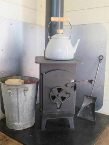 a stove with a tea kettle on top of it at Wilderness B&B 3 Self Contained Rooms Nr Sissinghurst in Headcorn