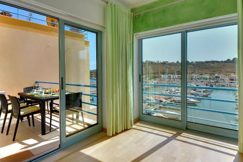 a balcony with a table and a view of a harbor at Marina Sand Residence in Albufeira
