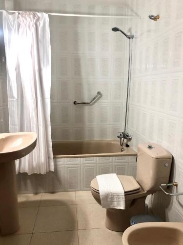a bathroom with a tub and a toilet and a shower at CASA LOS VIEJOS in Frontera