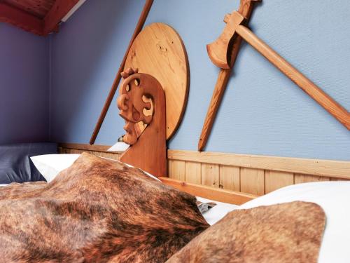 a dog laying on a bed next to a pillow at Gudvangen Fjordtell in Gudvangen