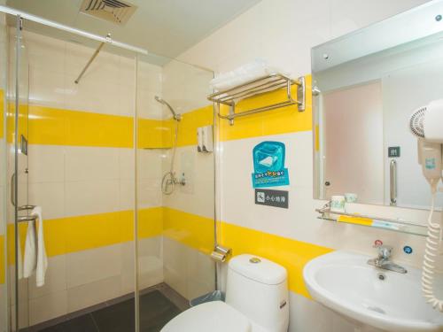 a bathroom with a toilet and a sink and a shower at 7Days Inn Guilin Yangshuo Shili Gallery in Yangshuo
