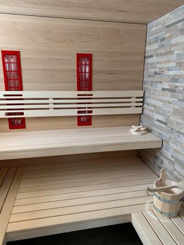 a bench in a room with two red windows at Haus Troger in Sankt Jakob in Defereggen
