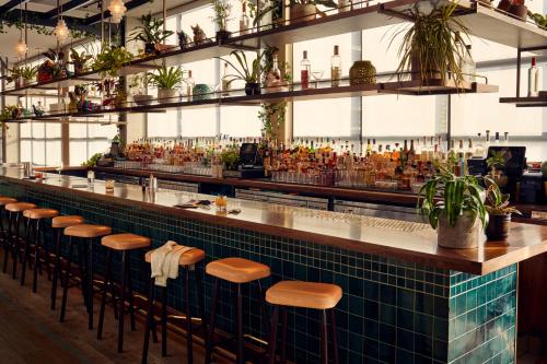 a bar in a restaurant with stools at The Hoxton, Chicago in Chicago