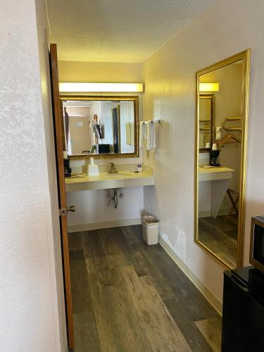 a bathroom with a sink and a mirror at Motel 6 Marianna, FL in Marianna