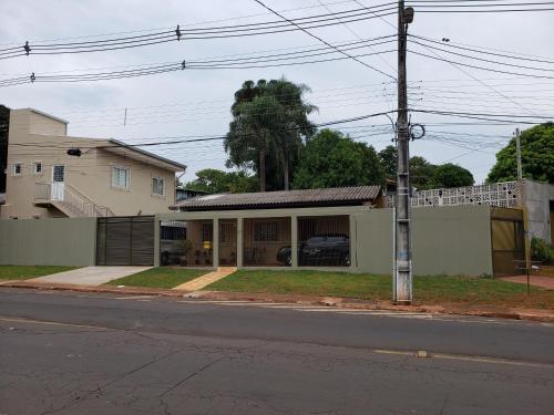 a house on the side of a street with at Felipe Family Houses - Casas de temporada in Foz do Iguaçu