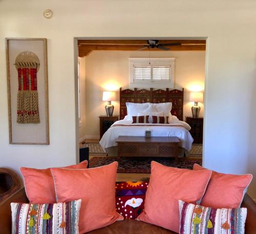 a bedroom with a bed and a couch in a room at Casa Culinaria - The Gourmet Inn in Santa Fe