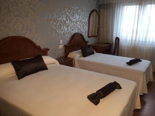 מיטה או מיטות בחדר ב-Villa De Foz