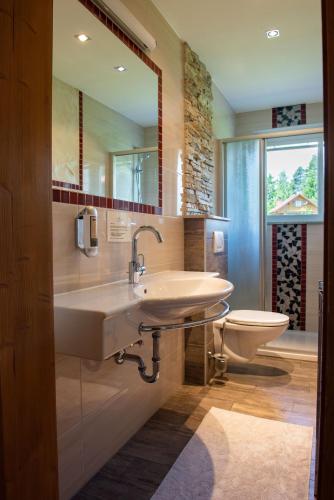 a bathroom with a sink and a toilet at Familiengasthof St. Wolfgang in Spittal an der Drau
