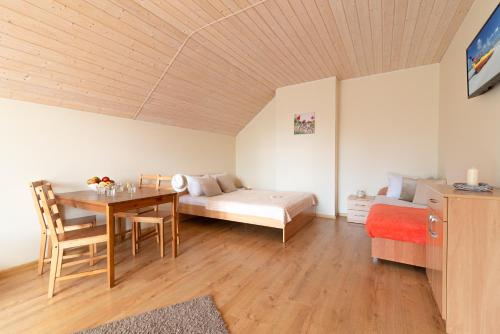 a room with a bed and a table and a bed and a bed at Pokoje VIERA in Karwia