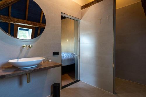 a bathroom with a sink and a mirror at Boutique hotel Lytel Blue in Riethoven