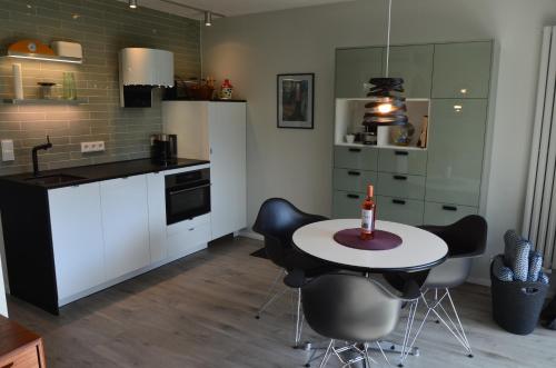 a kitchen with a table and chairs in a room at Apartment Moore in Reit im Winkl
