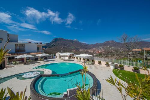 a pool at a resort with mountains in the background at Hotel le Rocce - Agerola, Amalfi Coast in Agerola