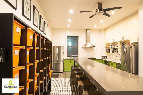 a kitchen with green and yellow cabinets and a refrigerator at The Clarence Park in Toronto