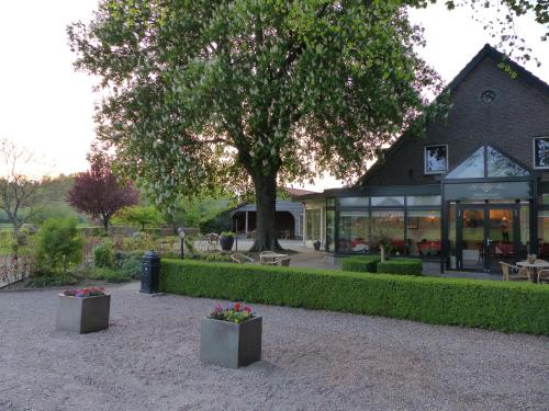 a building with a tree in front of it at Wildenborcherhof in Vorden