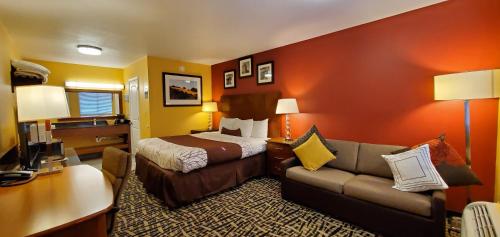 a hotel room with a bed and a couch at Apple Inn Motel in Chelan