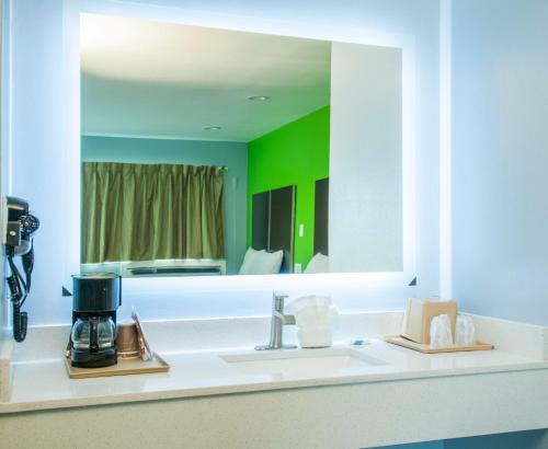 a bathroom with a sink and a mirror at Executive Inn Fort Stockton in Fort Stockton