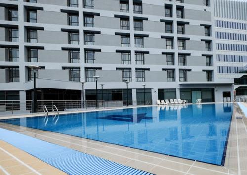a large swimming pool in front of a building at YWCA Fort Canning in Singapore
