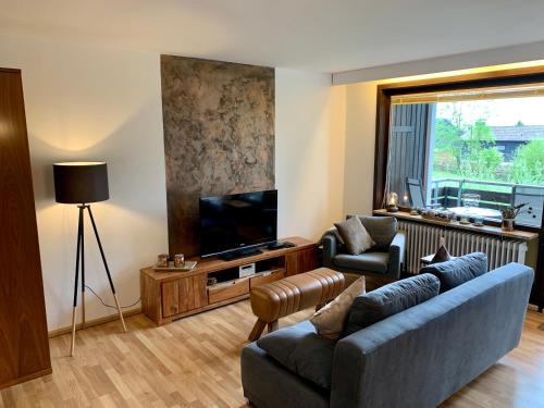 a living room with a couch and a television at Kupferstollen in Sankt Andreasberg