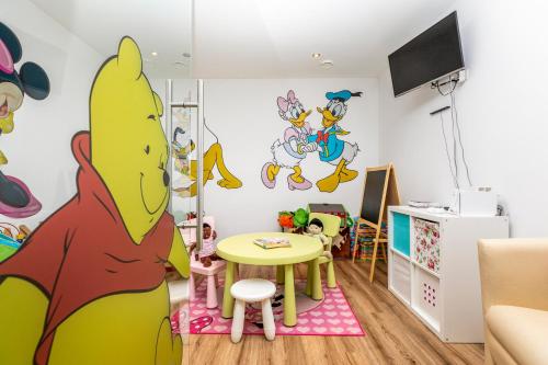 a childs room with a cartoon mural on the wall at Enjoy The Alps in Flachau